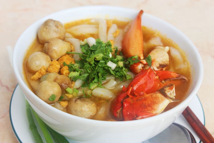 A bowl of soup with crab