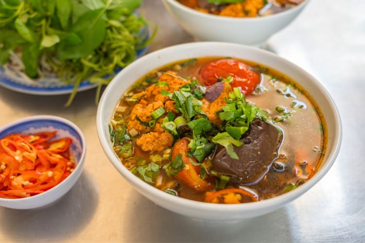 Soup with meat, vegetables and a tomato broth