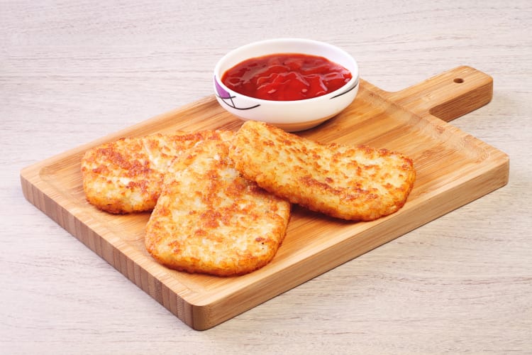 Three hash brown sticks and a jar of sauce, showcasing a Whataburger breakfast menu item
