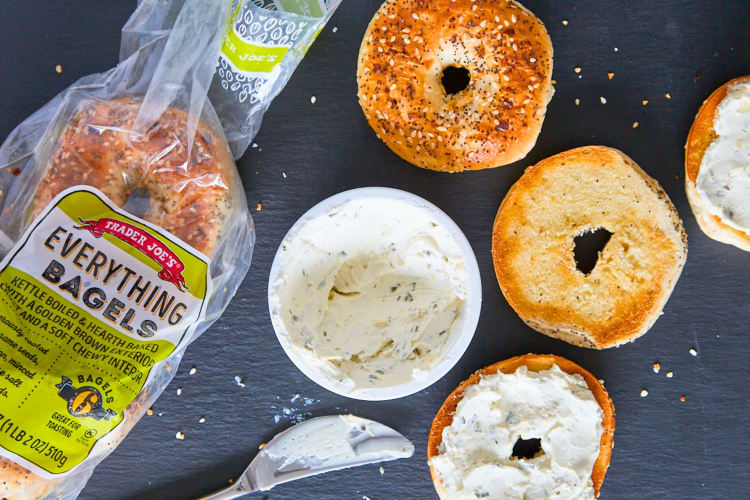 A bag everything bagels next to bagels with cream cheese