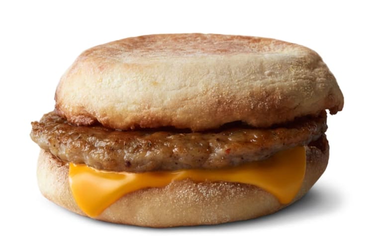 An English muffin with a sausage patty and American cheese