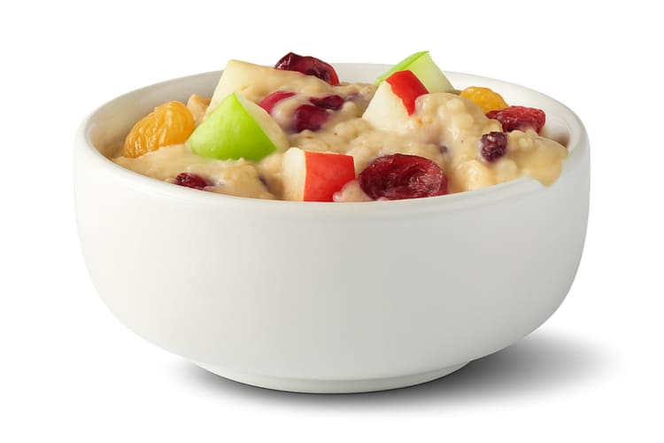 A bowl of oatmeal with apple and dried fruit from McDonald's