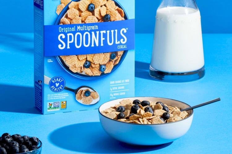 A blue box of cereal next to a blue bowl of cereal