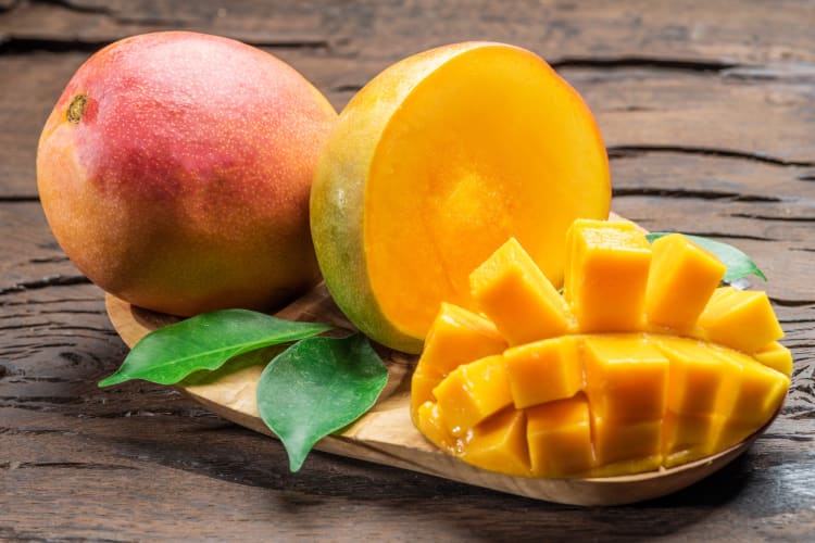 A mango cut if half and cubed