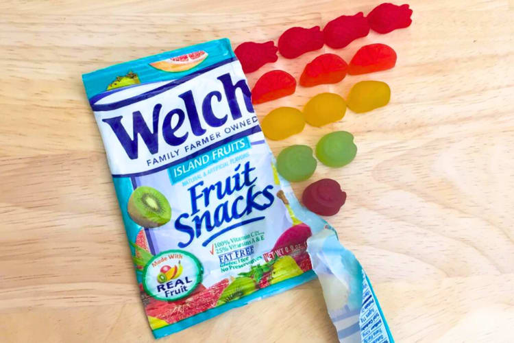 A blue bag next to colorful fruit gummy snacks
