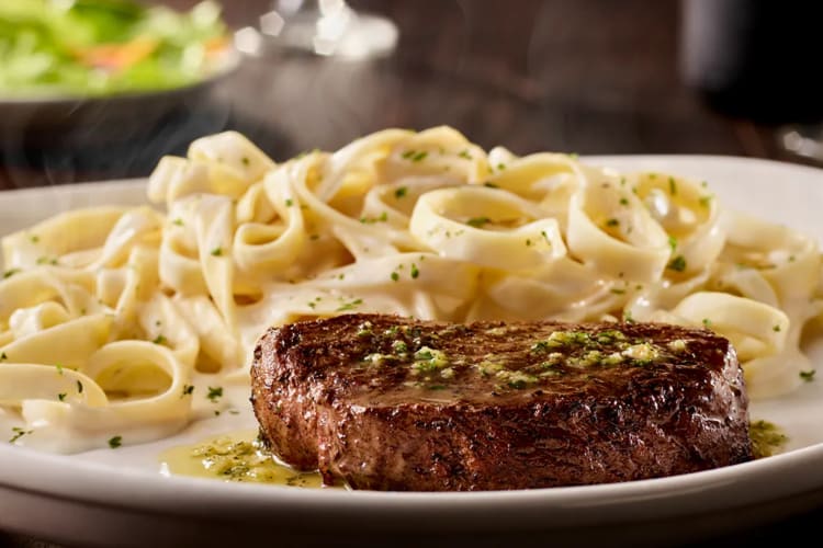 A sirloin steak and fettuccine Alfredo