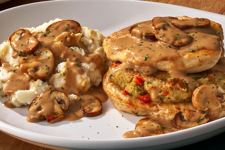 A plate of chicken Marsala with mashed potatoes