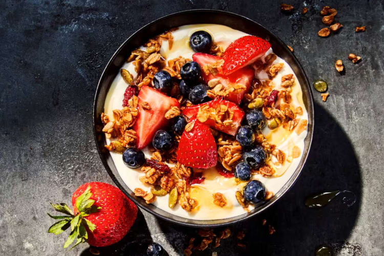 A bowl of yogurt with berries and granola