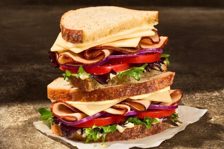 A sandwich with turkey and salad