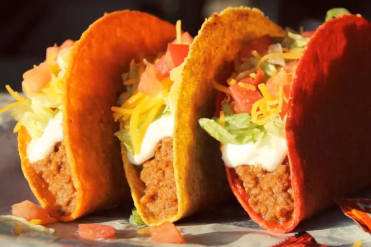 Three Doritos Locos Tacos with meat, cheese, sour cream and salad toppings