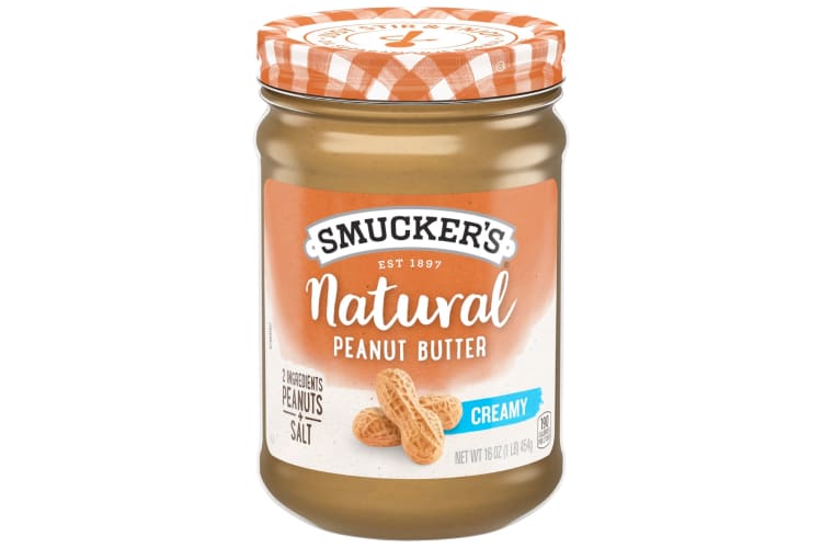 A jar of Smuckers peanut butter with orange and white branding