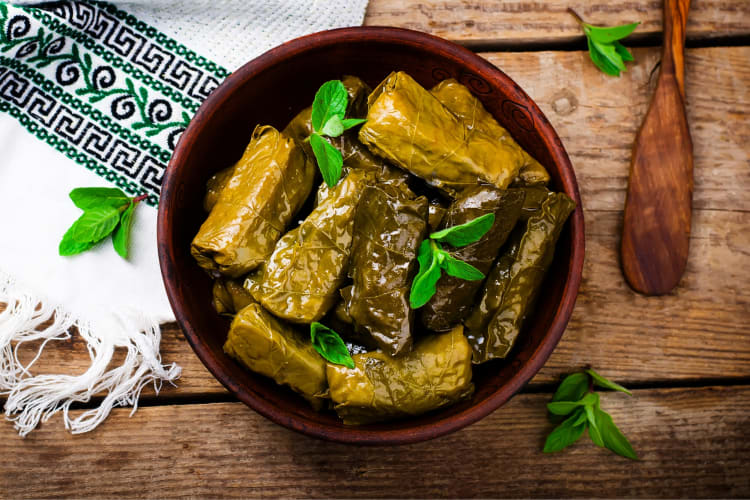 Dolamas in a wooden bowl on a wooden table