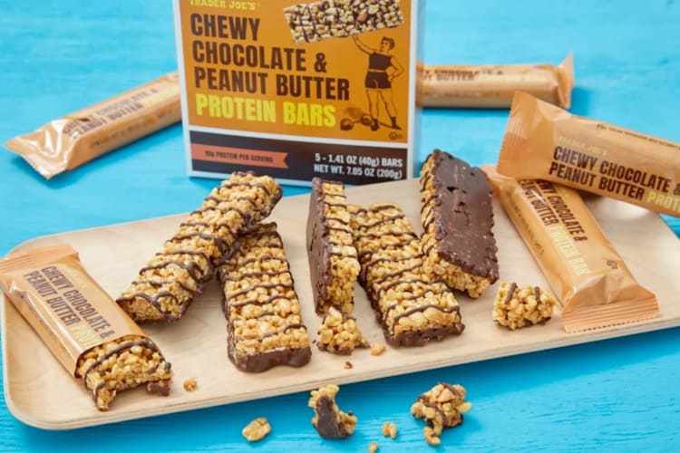 Chocolate and peanut butter cereal bars on a wooden tray