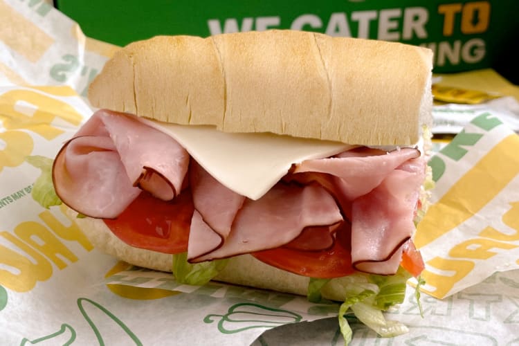 A sub with deli meat and salad