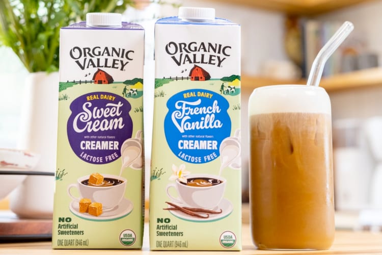 Two coffee creamer containers next to an iced coffee drink