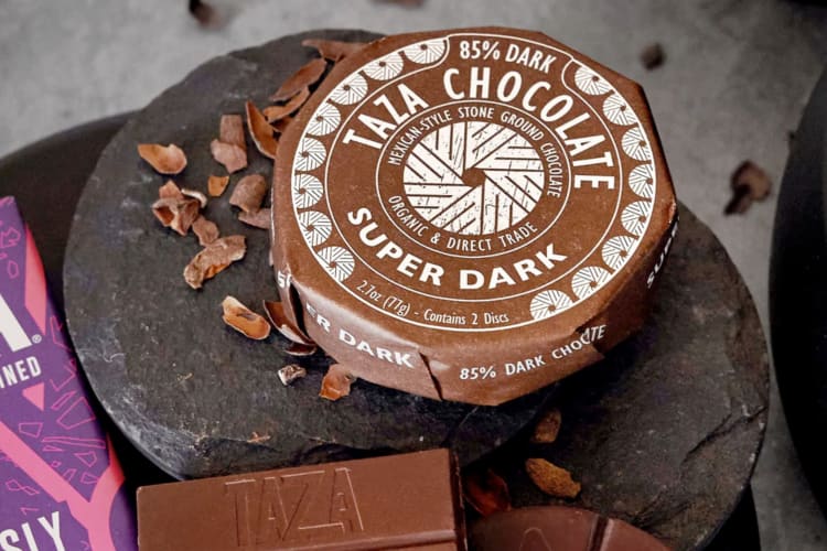 A chocolate disc wrapped in brown paper