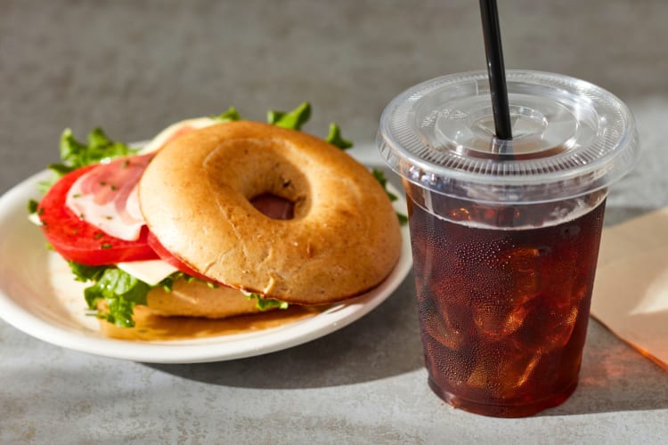 A bagel sandwich and an iced coffee