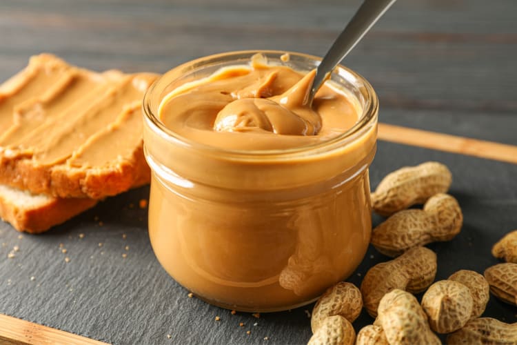 A jar of peanut butter with a spoon