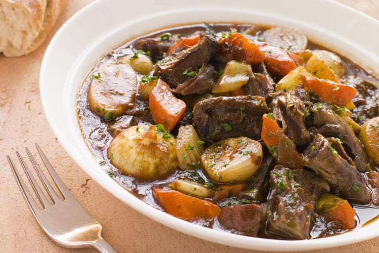 Stewed oxtail dish with a fork next to it