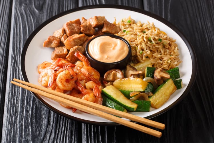 A hibachi plate with shrimp, rice and vegetables