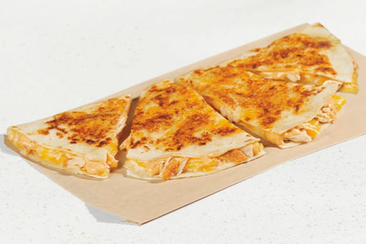 A Taco Bell Cantina Chicken Quesadilla cut into four pieces