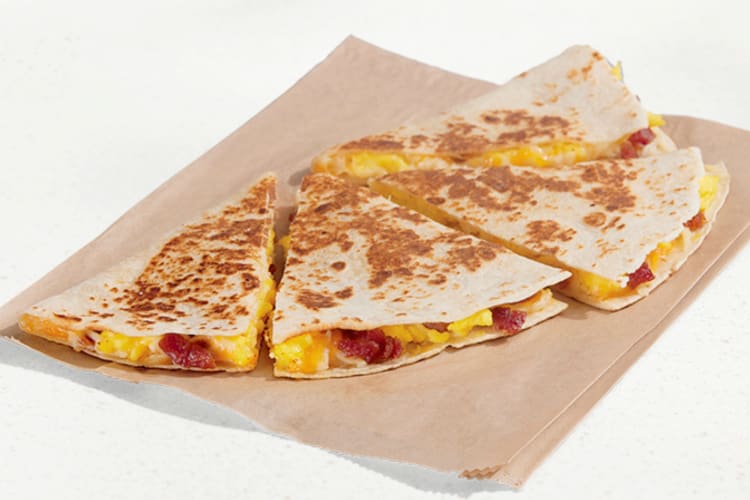 A Taco Bell Bacon Breakfast Quesadilla cut into four pieces