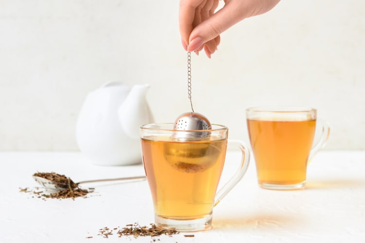 A person making hojicha tea