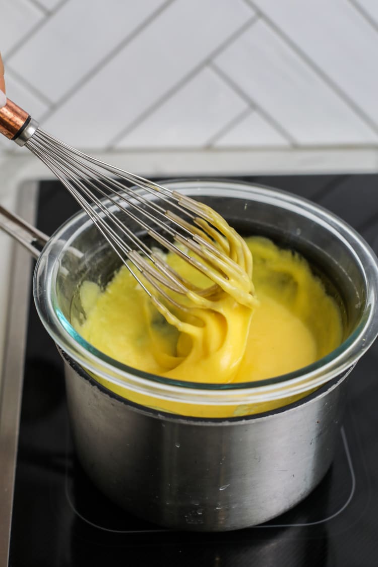 hollandaise being whipped on the stove