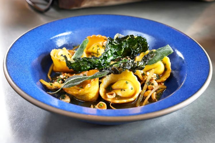 A blue bowl with homemade pasta
