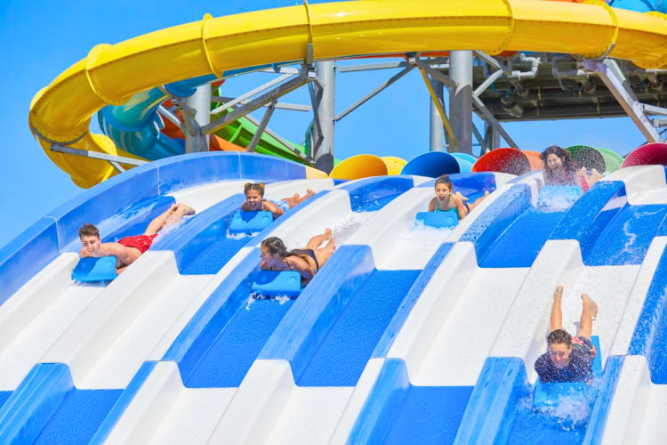 A blue and white water slide with people on it