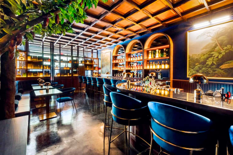 A bar with blue seating and gold accents