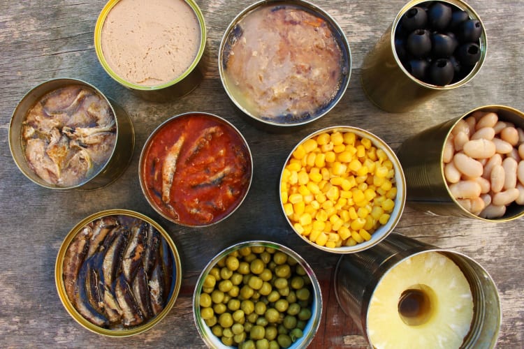 You should never store food in open cans as the metal can react with the food once the factory seal is broken.