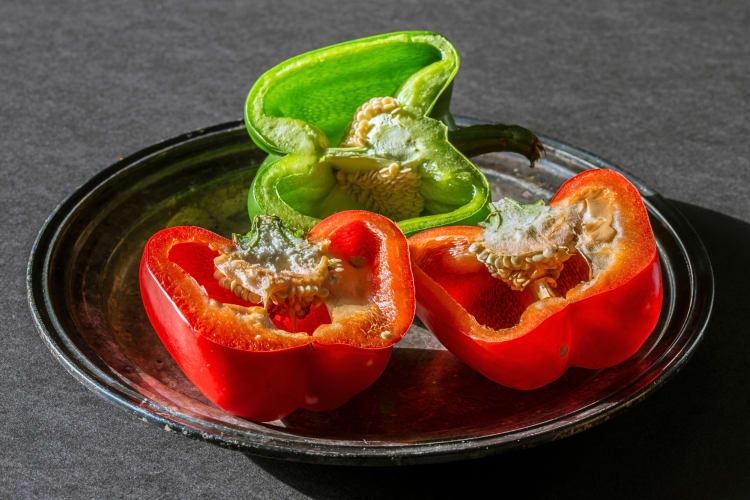 Three bell pepper halves sitting on a plate