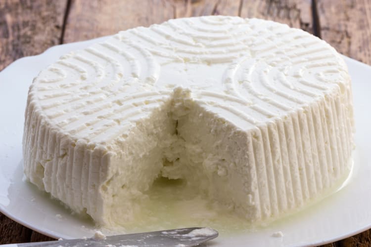 Ricotta cheese block with a missing portion