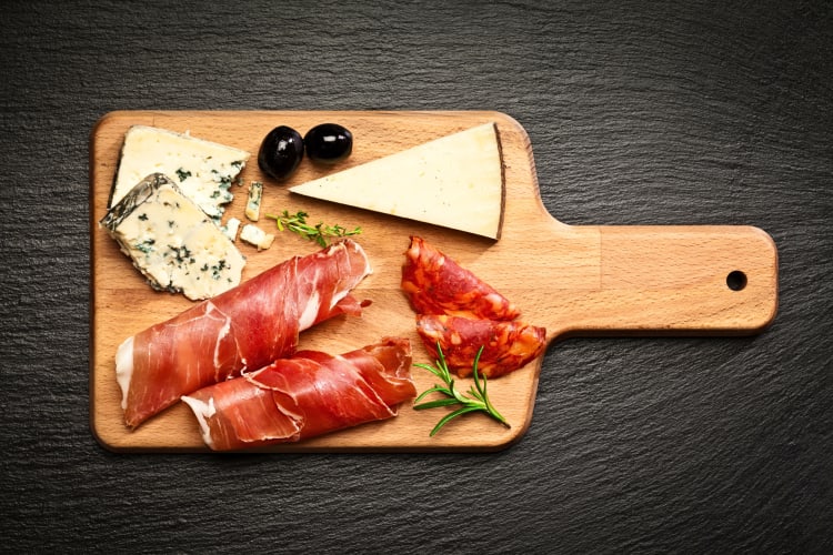 Top-view of a prosciutto and cheeseboard 