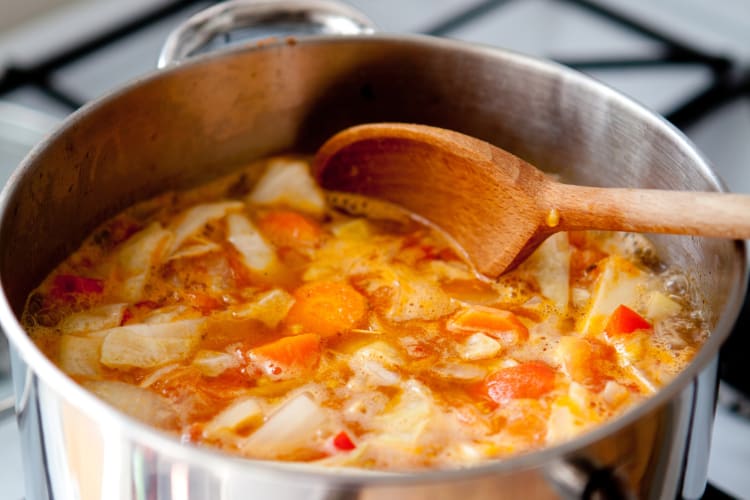 A pot with a broth on the stove