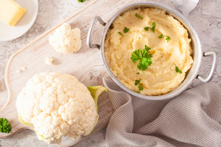 A cauliflower next to mashed cauliflower