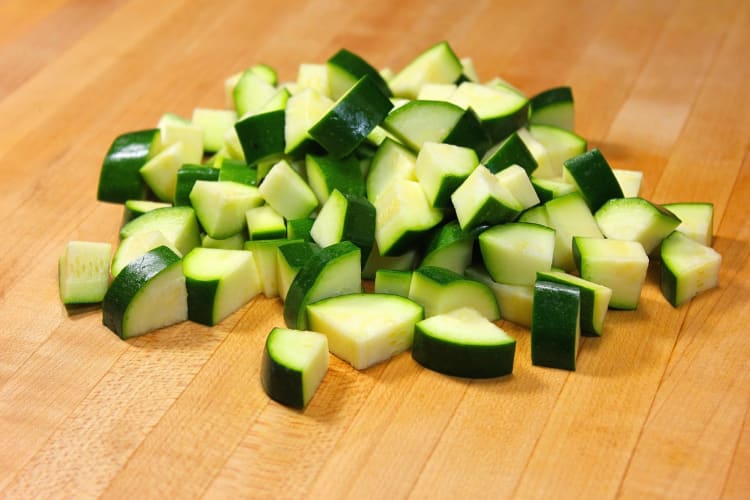 Zucchini cubes on a wooden surface