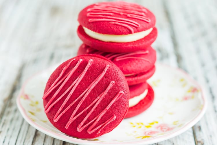 Red macarons with white frosting filling