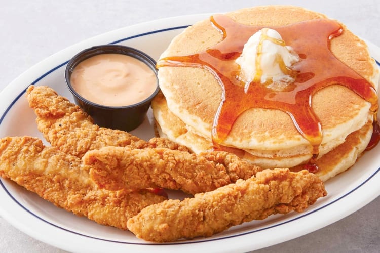 Fried chicken strips and buttermilk pancakes with syrup and butter