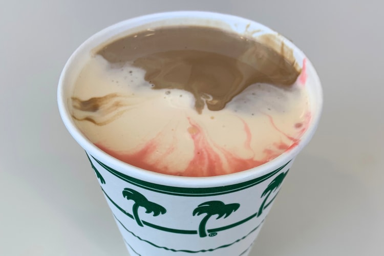 A milkshake with strawberry, chocolate and vanilla