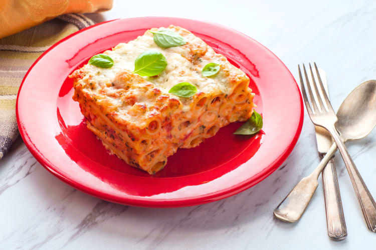 Baked ziti on a red plate