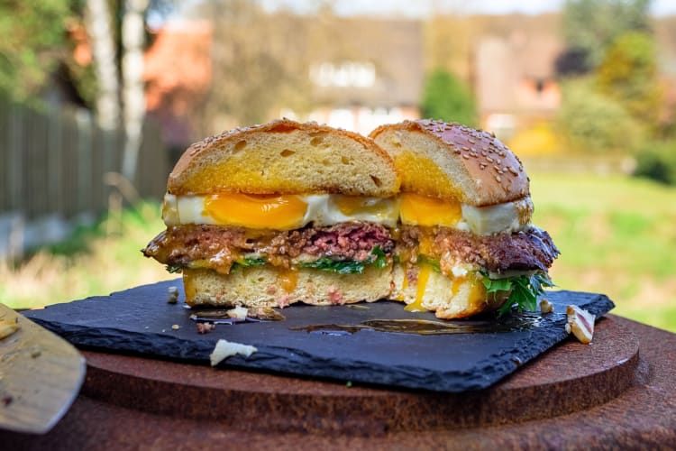 Breakfast burger with egg and lettuce cut in half