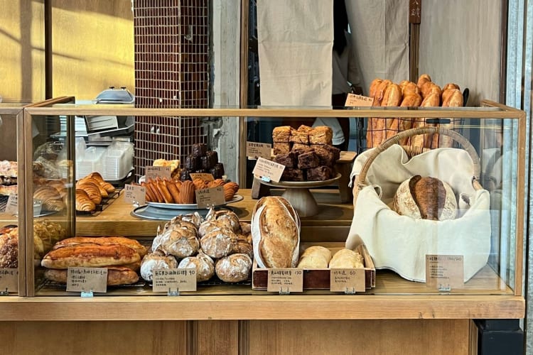 Sourdough breads in a bakery window.