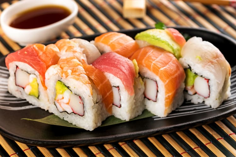 A selection of rainbow roll sushi with different types of fish
