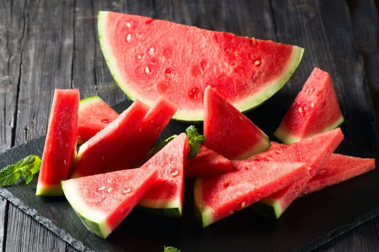 Slices of watermelon on a slate board