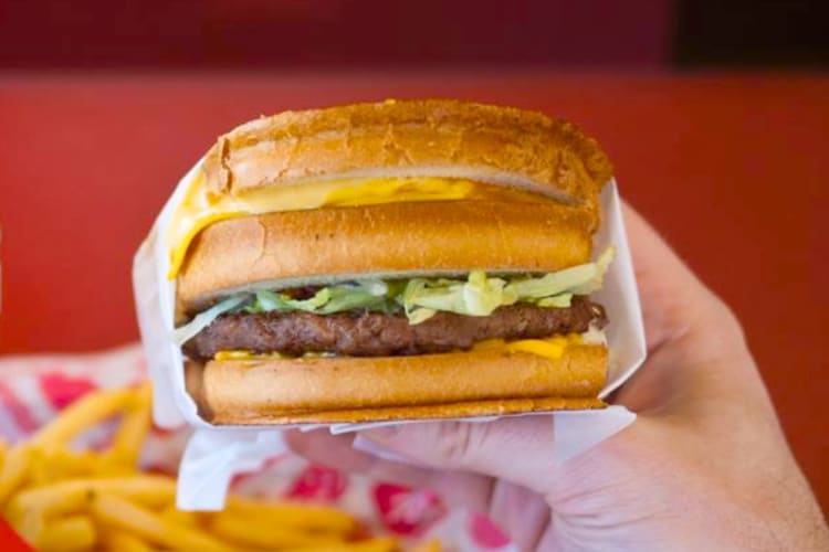 A sourdough burger with a grilled cheese sandwich on top