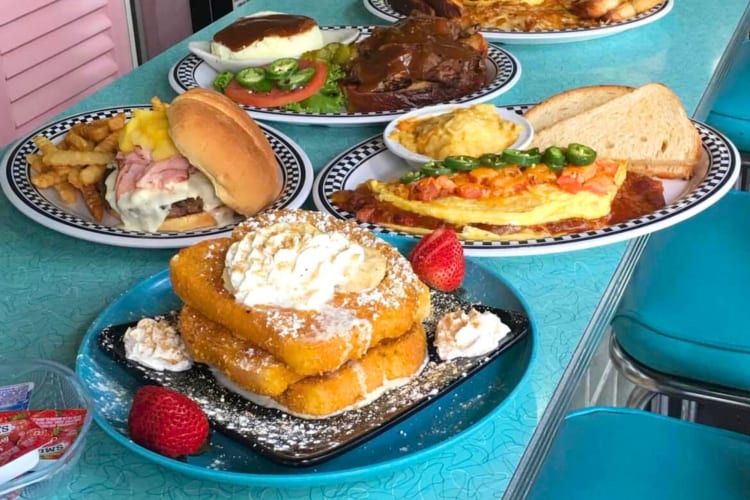 A range of breakfast dishes on a diner counter