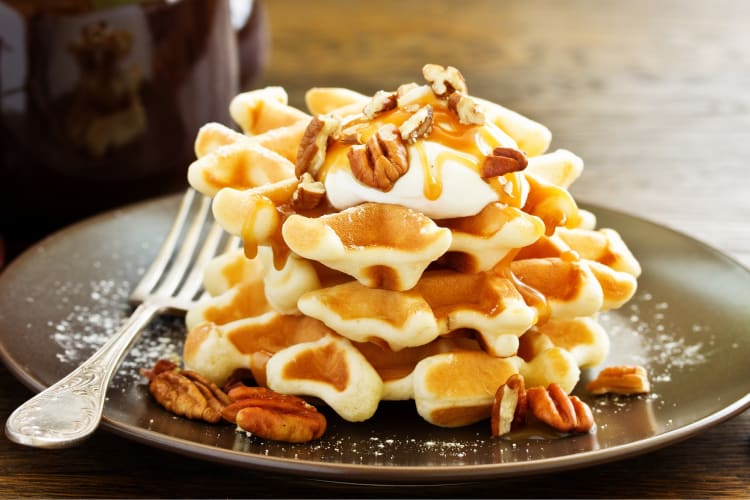 A waffle with caramel and pecans