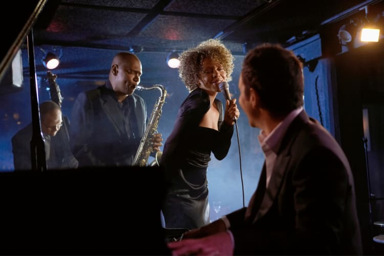 Singer and pianist looking at each other during a jazz club performance